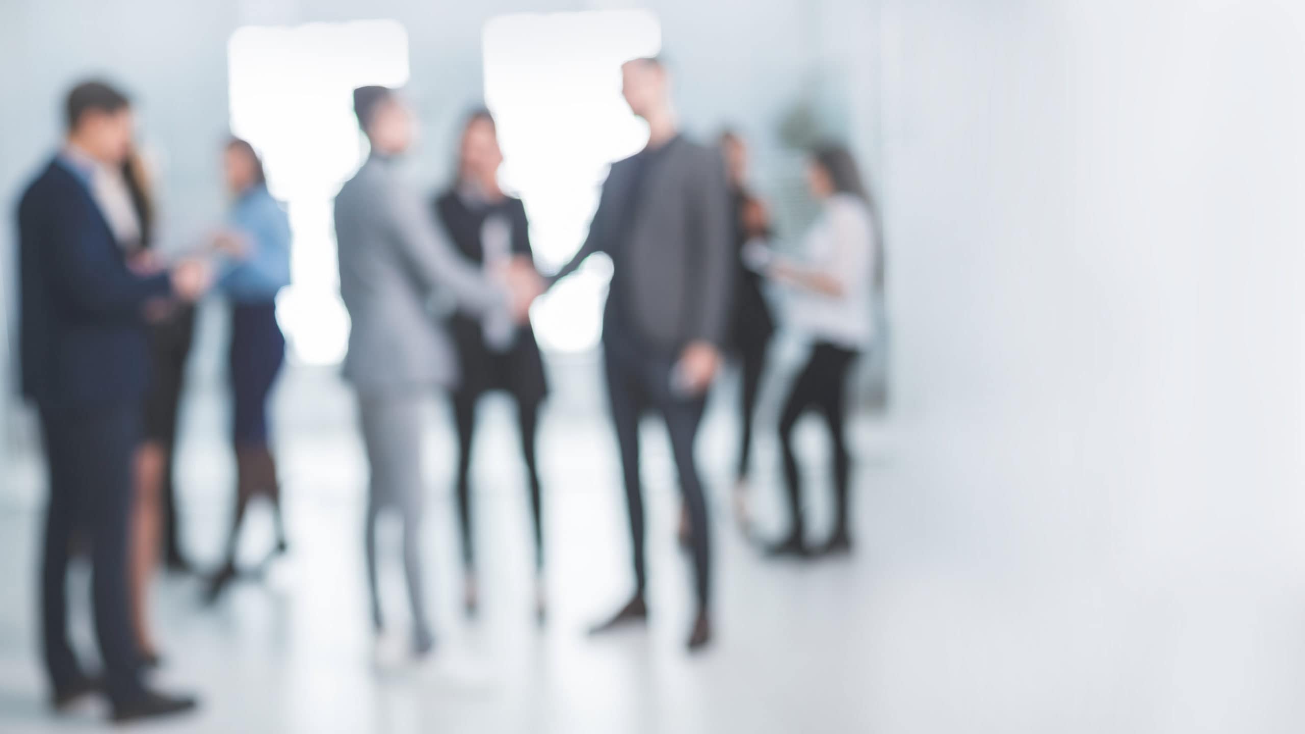 background image of a group of corporate employees in the office lobby